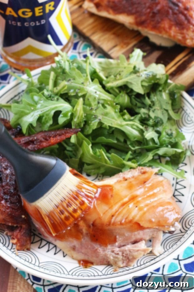 Beer Brined Beer Can Chicken grilling on a Traeger