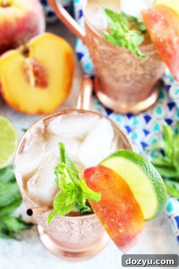 Two vibrant Peach Mint Moscow Mules ready to be enjoyed