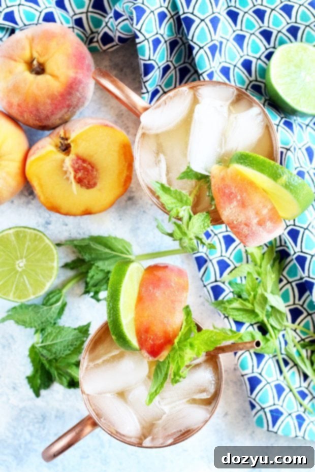 Peach Mint Moscow Mule garnished with fresh fruit slices and mint