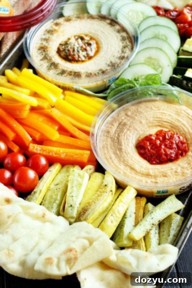 Summer Garden Veggie Hummus Platter 9 A close-up of hummus with roasted vegetables and pita bread