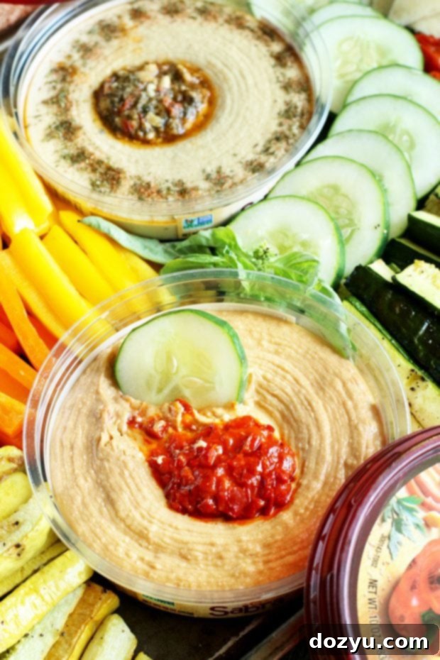 Summer Garden Veggie Hummus Platter 5 Colorful raw and roasted vegetables arranged around hummus on a board