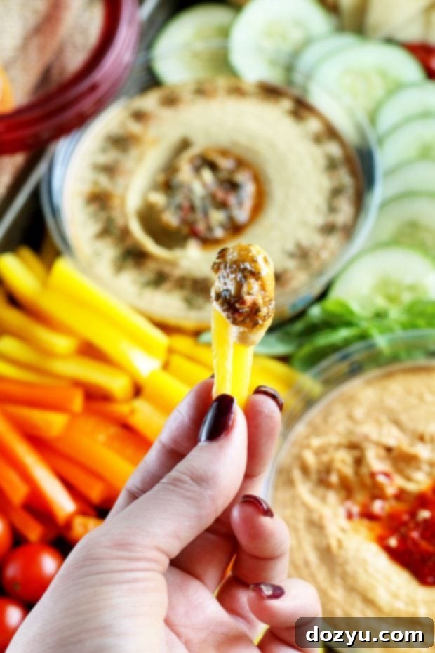 Summer Garden Veggie Hummus Platter 6 A vibrant spread of raw vegetables like bell peppers and cucumber with hummus