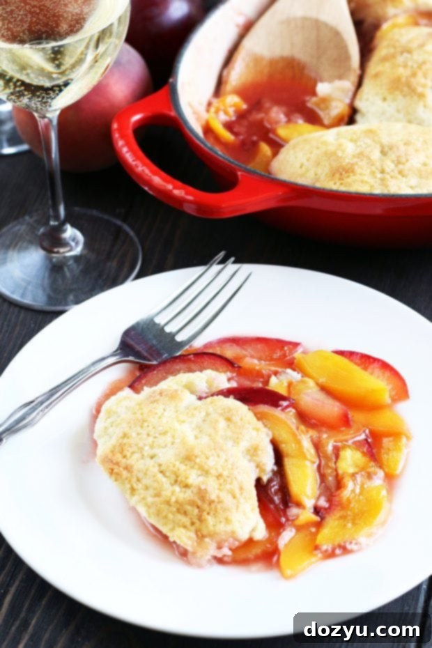 A large baking dish filled with bubbling Peach Plum Cobbler