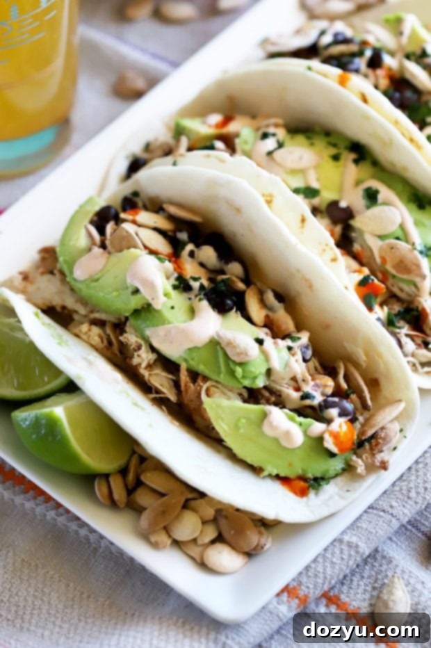 Autumn Spiced Chicken Tacos 7 Close-up of a single Pumpkin Spice Chicken Taco with crema drizzle