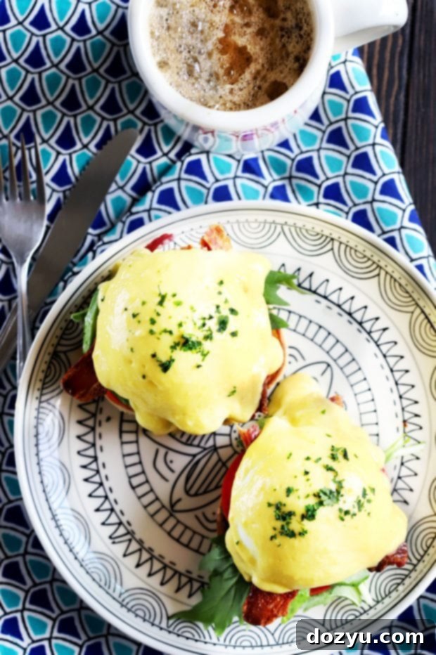 A BLAT Eggs Benedict serving, showcasing the vibrant colors and appealing layers of ingredients.