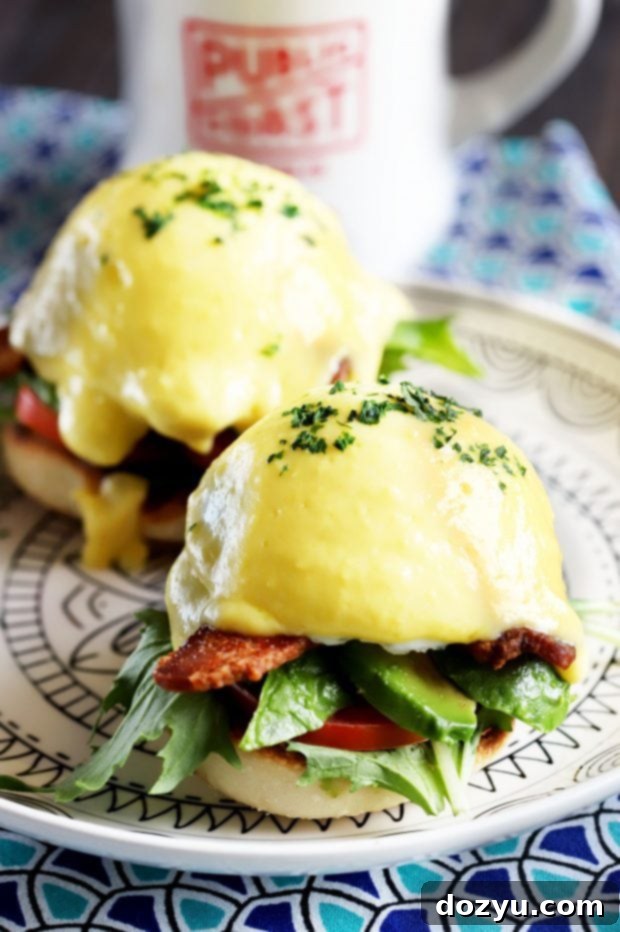 BLAT Eggs Benedict, ready to be served, highlighting the layers of bacon, lettuce, avocado, tomato, and poached egg.
