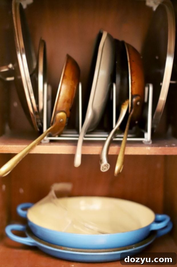 Pantry shelf with organized baskets, labeled for different food categories