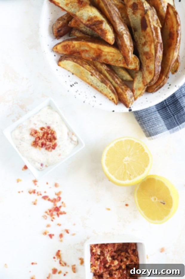 Smoky Bacon Aioli 3 Overhead image of bacon aioli in a white bowl on a textured background.