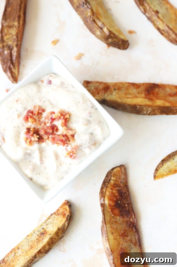 Smoky Bacon Aioli 7 Overhead image of a bowl of bacon aioli surrounded by a basket of golden fries.