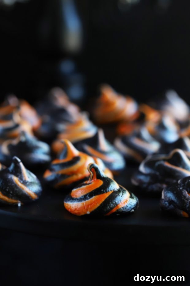 Close-up of bright orange and black meringue swirls