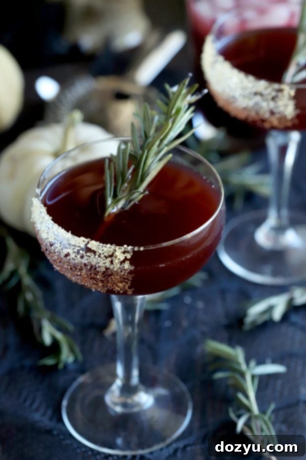 Two Spooky Pomegranate Mezcal Cocktails with Halloween decorations, ideal for a party