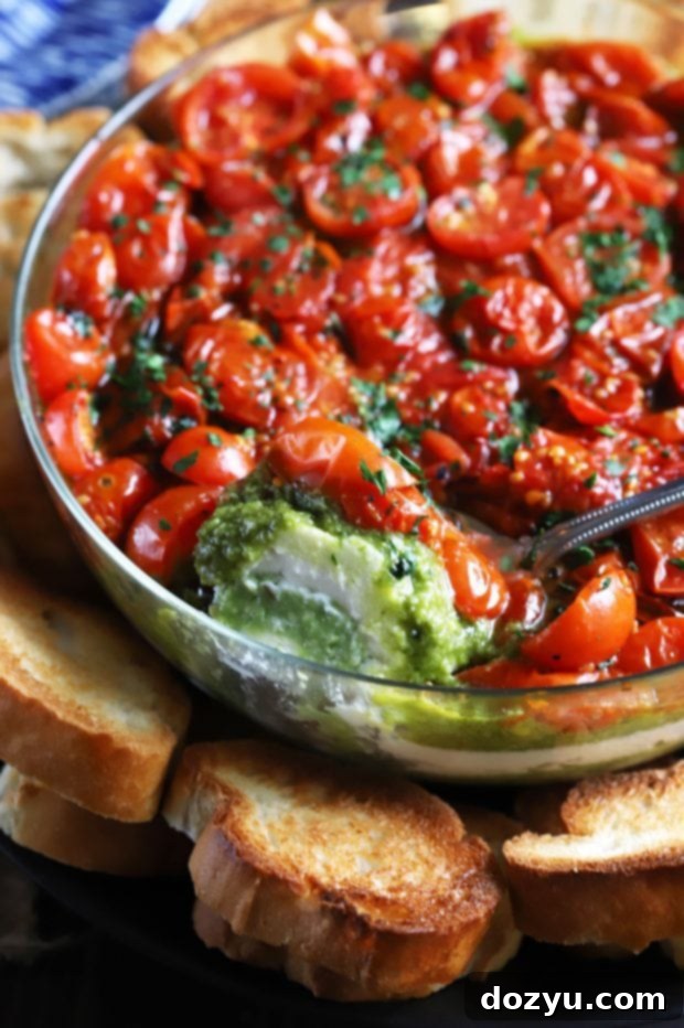 Close-up of Avocado Ricotta Tomato Pesto Layer Dip in a glass bowl