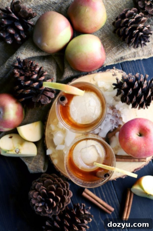Apple Pie Old Fashioned Cocktail 6 Pouring Apple Pie Infused Whiskey into a glass