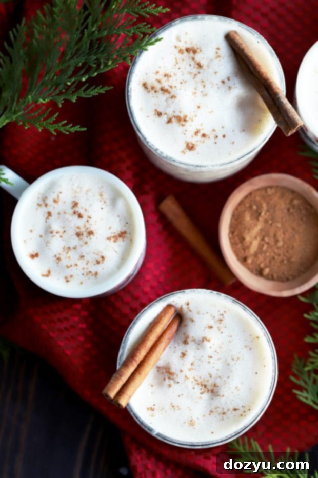 Glasses filled with The Best Homemade Eggnog ready for a party