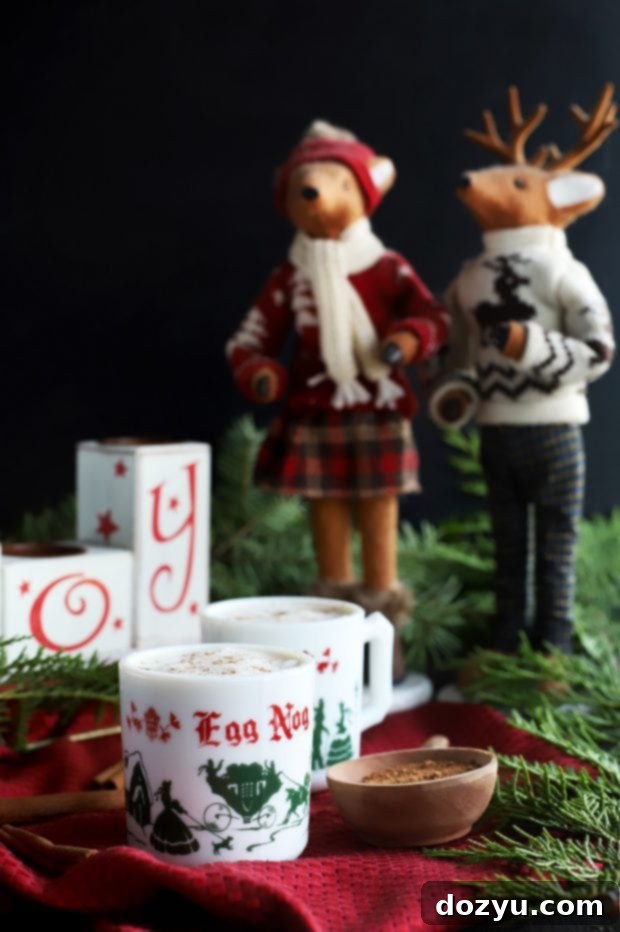 A festive holiday setting with a mug of The Best Homemade Eggnog