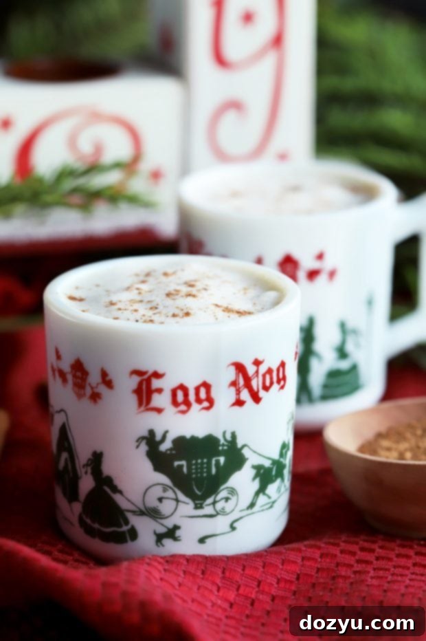 Traditional glasses filled with The Best Homemade Eggnog for an old fashioned holiday celebration