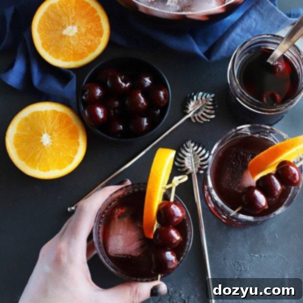 Perfect Manhattan Punch thumbnail with a vibrant red drink and garnishes
