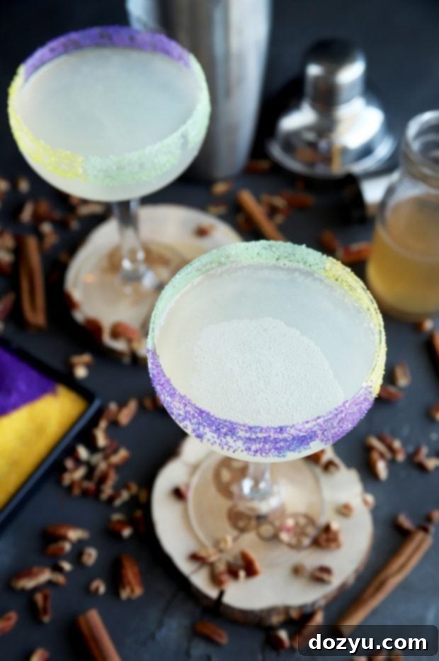 Close-up of a King Cake Daiquiri, showcasing the vibrant sugar rim and clear cocktail.