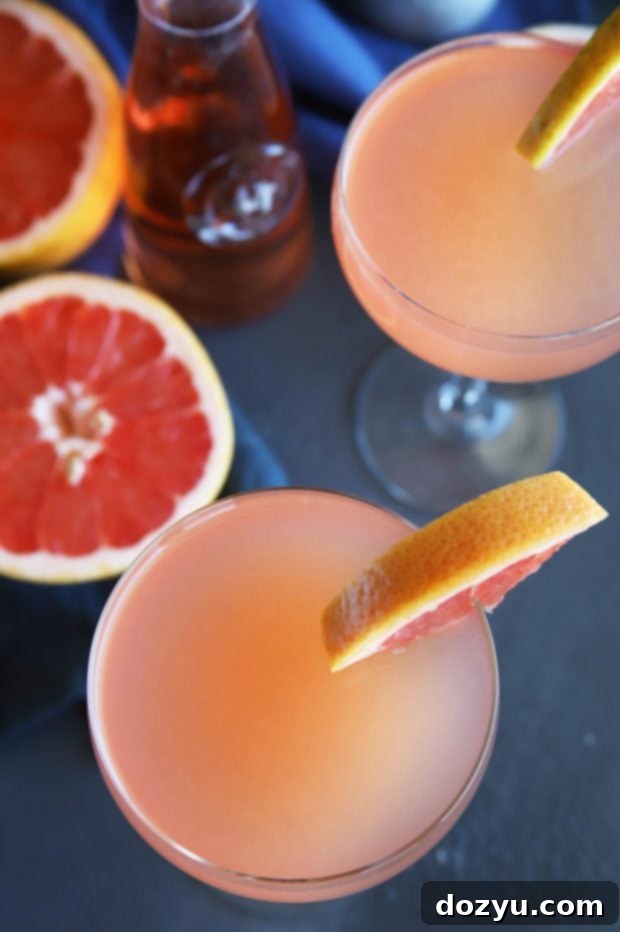 Rosé Grapefruit Sparkler 5 Two glasses of Sparkling Grapefruit Rosé Cocktail on a table, ready for a refreshing break on a sunny day.