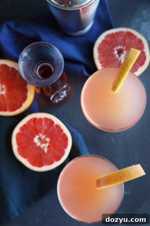 Rosé Grapefruit Sparkler 6 A close-up shot of a Sparkling Grapefruit Rosé Cocktail with ice and a grapefruit slice, emphasizing the fresh ingredients.