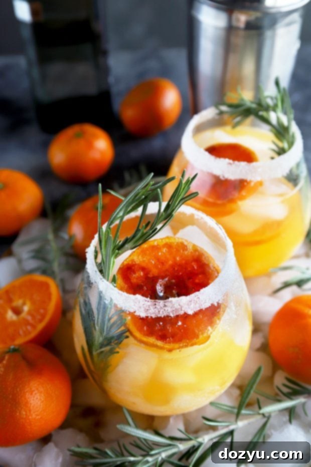 Clementine Mezcal Margarita in a wine glass with a brûléed clementine slice