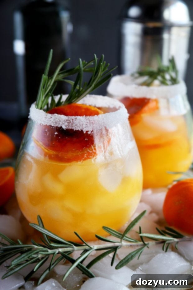 Clementine Mezcal Margarita garnished with rosemary and brûléed clementine