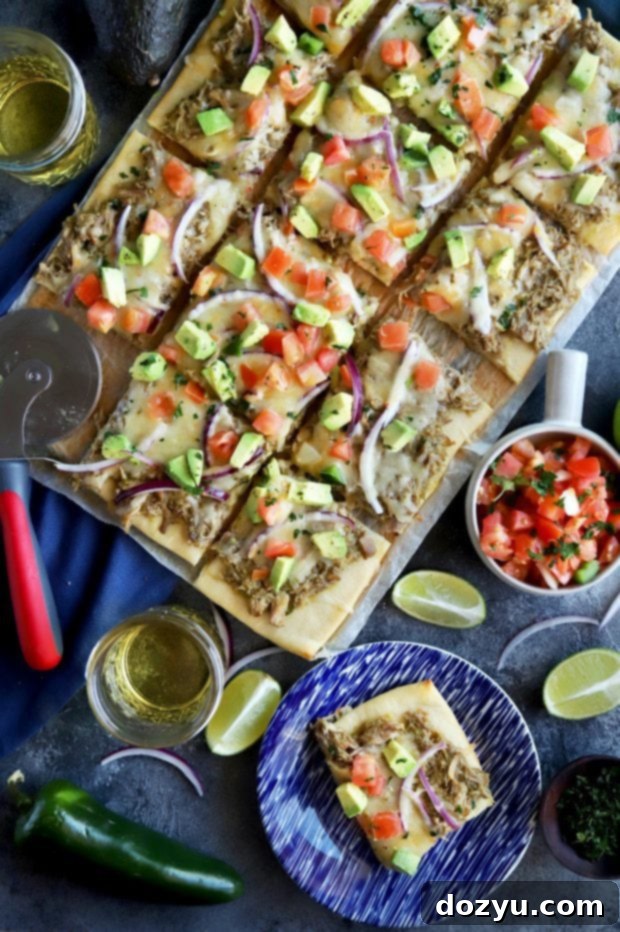 Assembling the Avocado Pulled Pork Flatbread with all its delicious toppings.