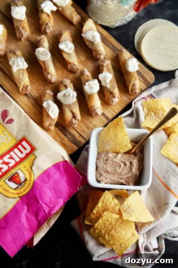 Tray of Churro Cheesecake Taquitos ready for serving at a festive party.