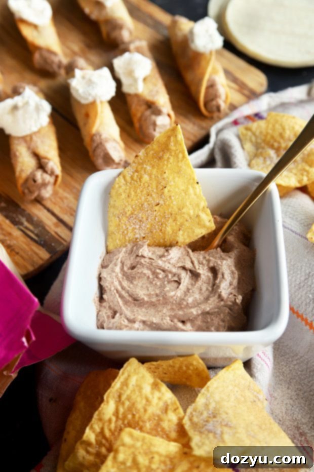 Churro Cheesecake Taquitos on a serving platter, highlighting their perfect golden fry.