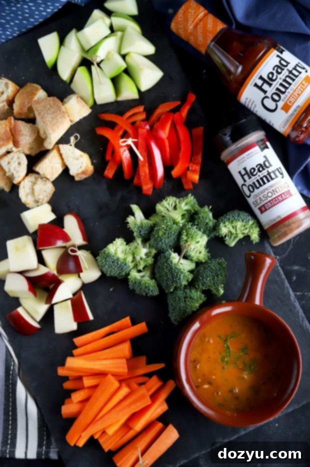 Chipotle Fondue Short Ribs 2 BBQ fondue dip, a rich and cheesy appetizer featuring tender short ribs and a smoky chipotle kick, perfect for dipping artisan breads and fresh vegetables.