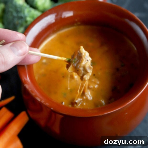 Chipotle Fondue Short Ribs 10 Apple dipping into cheese BBQ fondue, a hearty and spicy appetizer perfect for sharing.