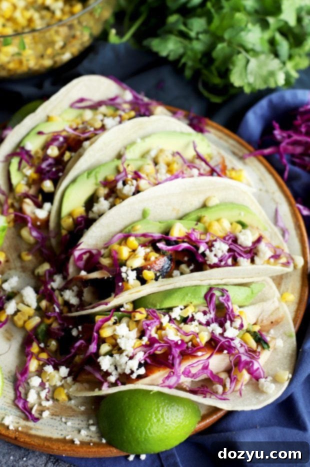 A vibrant platter of Charred Corn Chicken Avocado Tacos