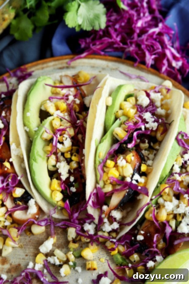 Close-up of Charred Corn Chicken Avocado Tacos on a white plate