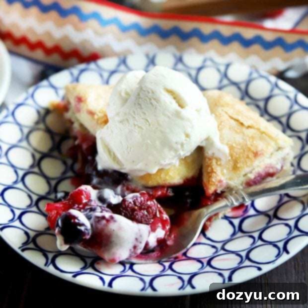 Thumbnail image of a rustic raspberry, blueberry, and strawberry galette, perfectly baked with a golden crust and glistening fruit.