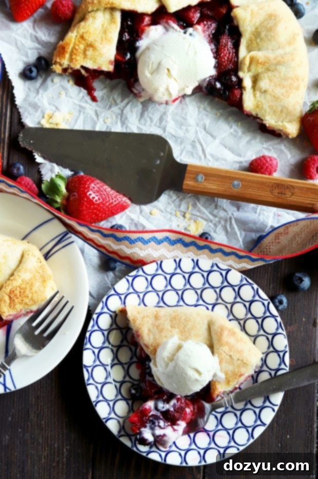 A person eating a slice of a triple berry galette topped with melting vanilla ice cream, capturing the deliciousness of the summer dessert.