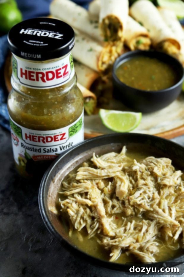Salsa verde chicken, freshly shredded, with a bottle of HERDEZ Roasted Salsa Verde in the background