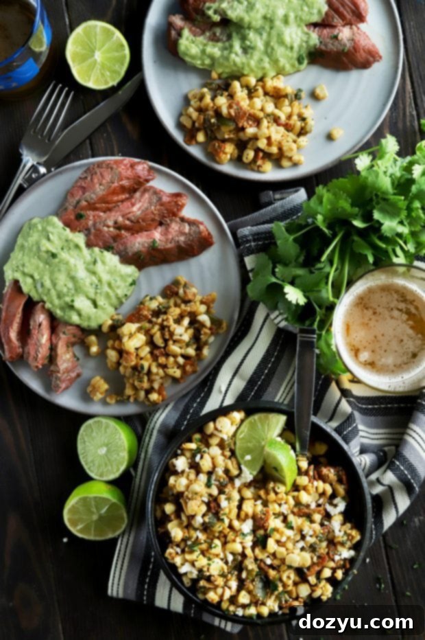 A spread of grilled corn salad with steak and limes