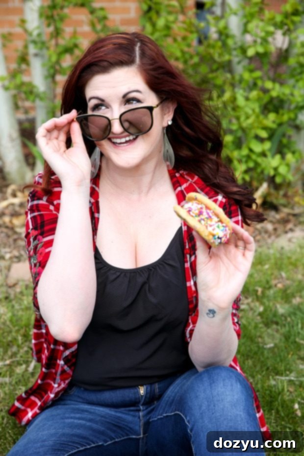 Woman happily holding a custom ice cream sandwich outdoors, delivered by Grubhub