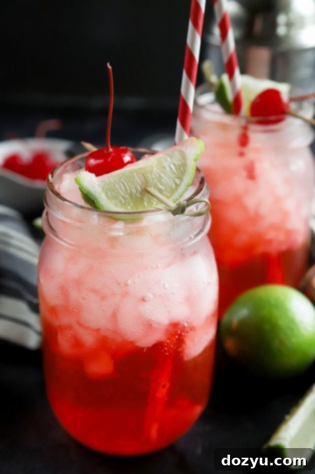 refreshing cherry limeade cocktail with maraschino cherry garnish