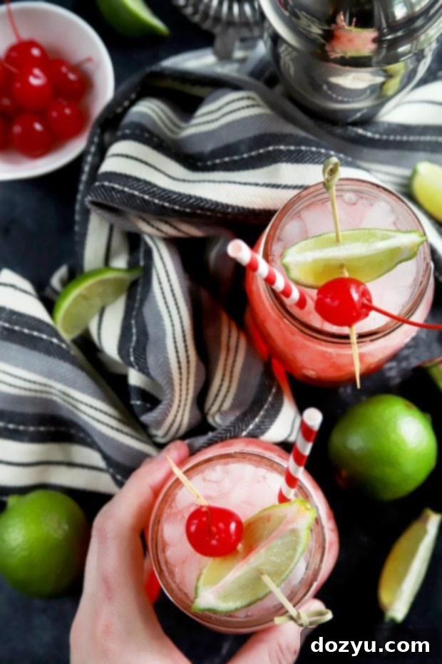 Overhead shot of cherry limeade cocktails in mason jars