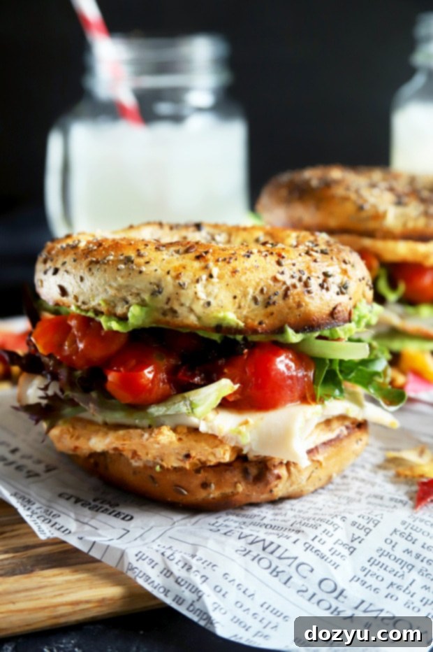Stacked turkey bagel sandwich