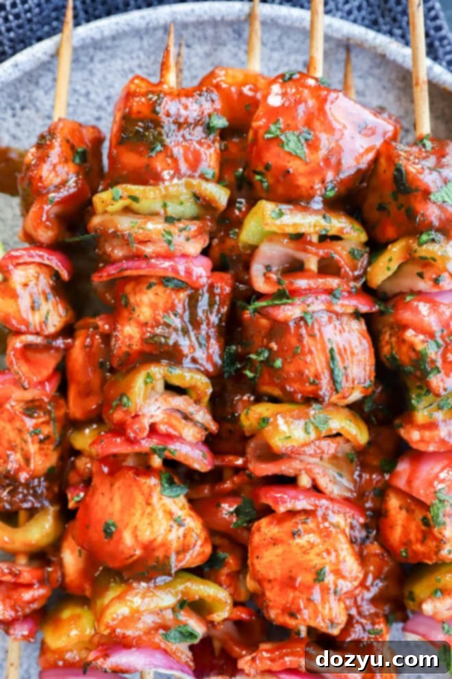 Kabobs made with chicken, bacon, onion, and bell pepper with bbq sauce