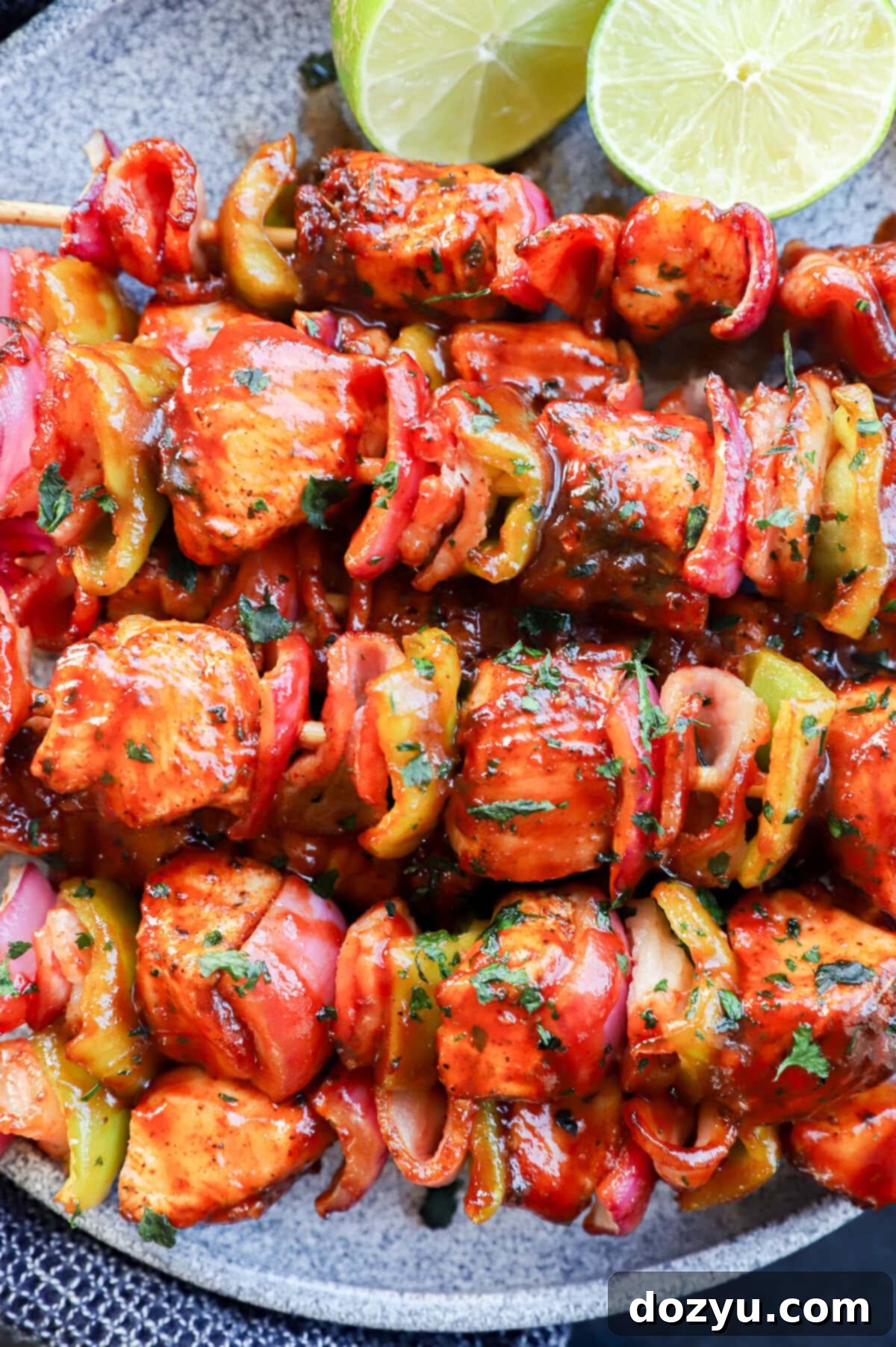 Skewers of chicken, bacon, onion, and bell pepper with bbq sauce