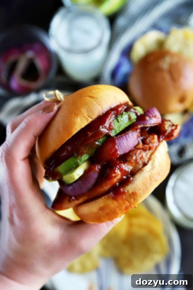 Holding a BBQ sandwich with chicken