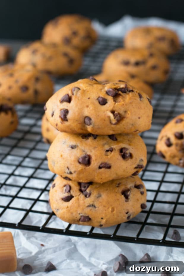 Gooey Caramel Pumpkin Cookies 3 Close-up of a stack of warm caramel stuffed pumpkin cookies