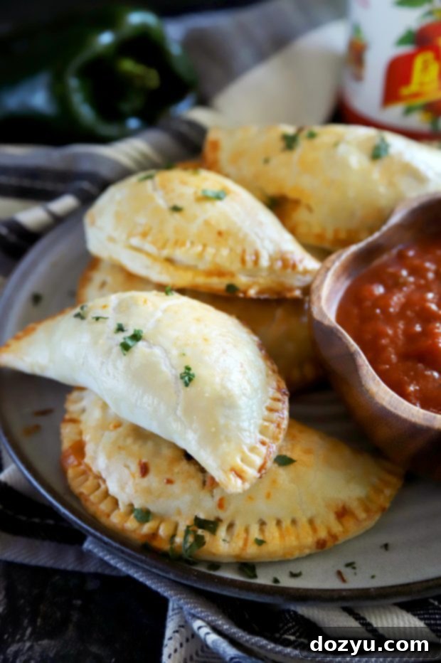 Poblano Chicken Enchilada Empanadas 3 Golden chicken empanadas in a pile