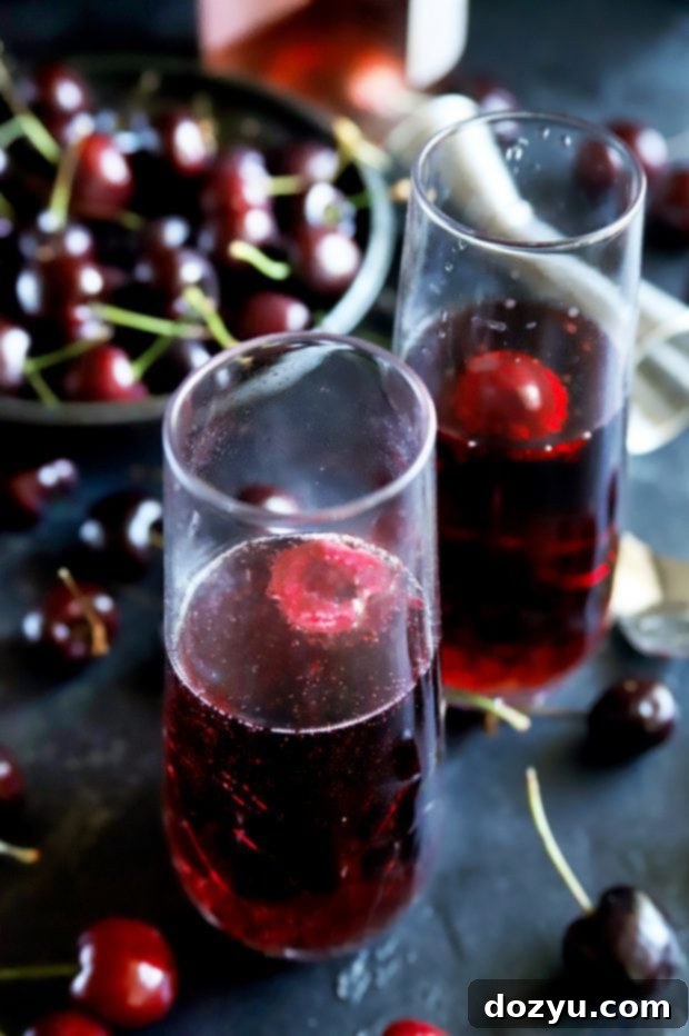 Blushing Cherry Rosé Mimosa 6 Side shot of champagne flutes with cherry rose mimosas and fresh cherries