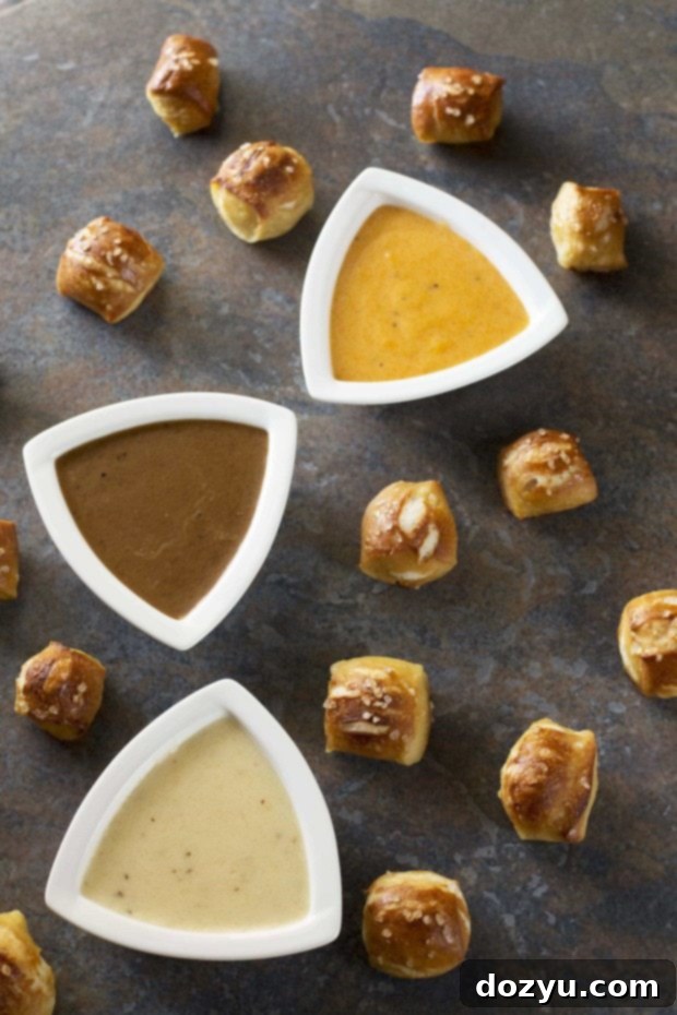 Pretzel bites and three bowls of beer cheese dips