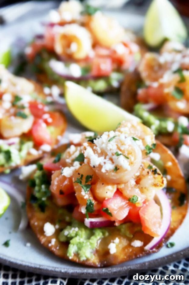 Close up of a shrimp tostada with limes