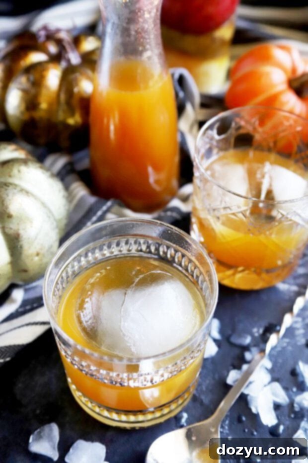 Spiced Autumn Bourbon Old Fashioned 2 Pumpkin Spice Bourbon Old Fashioned cocktails with autumn decor